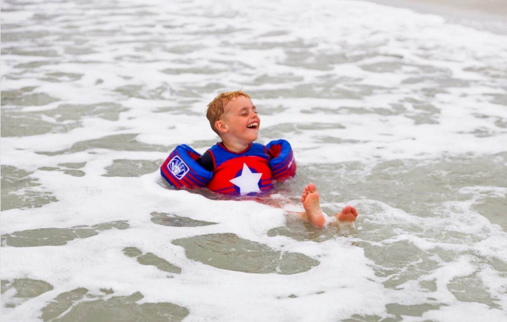 boy plays in shore on sanibel beach
